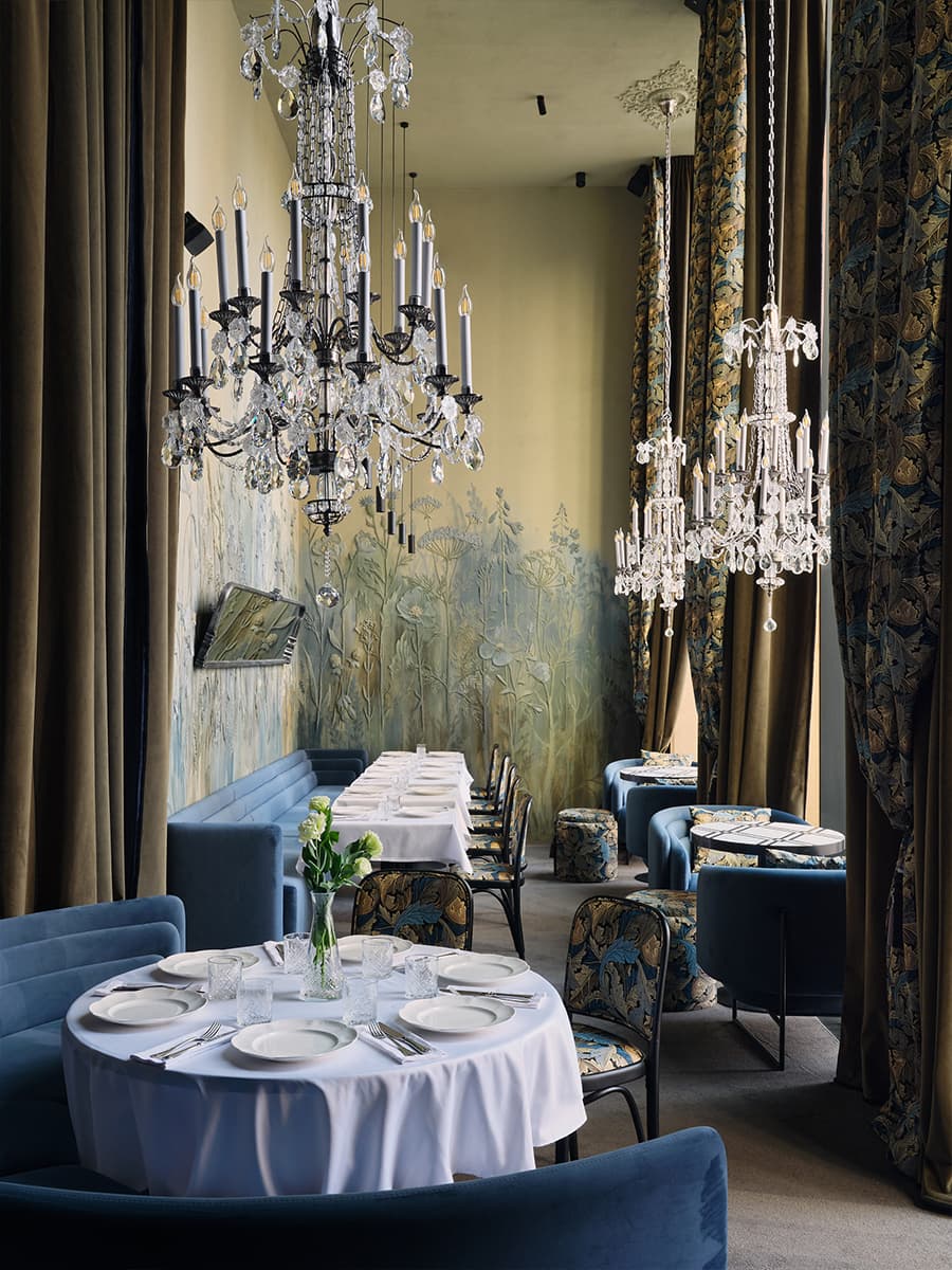 Многоярусные люстры и изящные книжные шкафы в интерьере ресторана — проект Алины Цауня